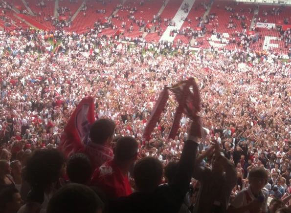  Cup of cheer: Adkins shows off the League 1 Runners Up Cup to the Southampton fans. Championship football follows the next season 
