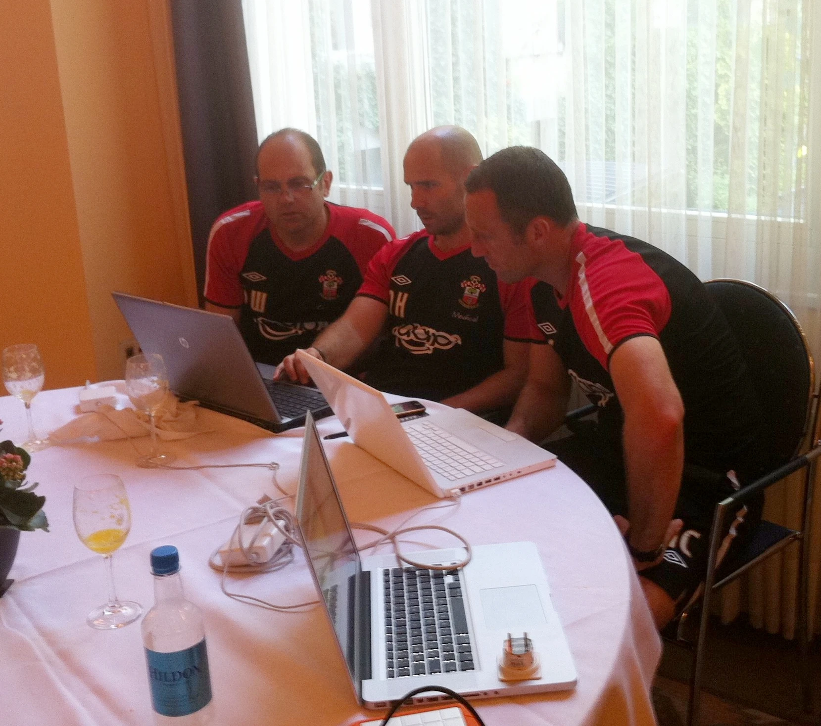 Collaboration between the Coaches in finalising the planning for the morning training session during Southampton's 2011 pre-season tour to Interlaken in Switzerland.  From the left 1st Team Coach Dean Wilkins, Head of Sport Science Nick Harvey and Assistant Manager Andy Crosby.